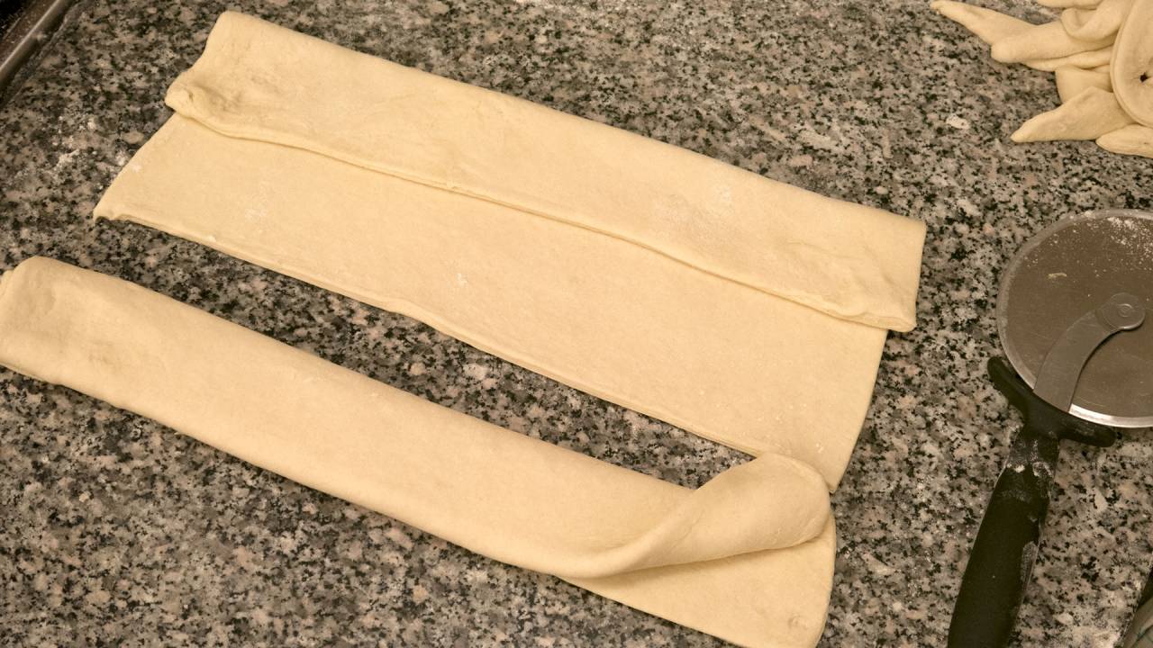 Croissant pastry folded in 3 layers on the short edge.